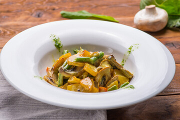 Stewed juicy vegetables and mushrooms