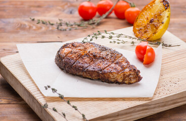Grilled salmon steak on a board
