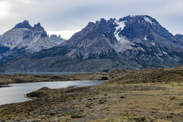 Impressive mountains and a lake with turquoise water at Torres del Paine National Park in Chile,...