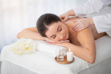 Obraz na płótnie Canvas Relaxing Massage. Beautiful Indian Female Enjoying Wellness Treatment In Spa Salon