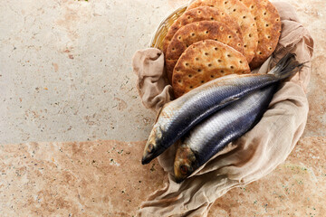 Catholic still life of five loaves of bread and two fish - obrazy, fototapety, plakaty