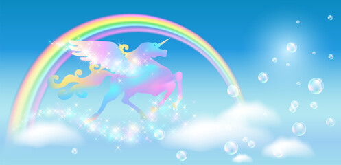 Galloping iridescent Unicorn Pegasus and rainbow in blue sky against the background of the fantasy universe with clouds and sparkling stars.