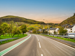 Senheim village houses on the road side and steep vinyards during autumn in Cochem-Zell district, Germany