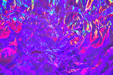 Abstract holographic background in 80s, 90s style. Modern bright neon colored crumpled metallic psychedelic holographic foil texture. Synthwave, vaporwave, retrowave, retro futurism, syberpunk