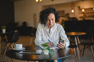 One woman mature female entrepreneur use smartphone phone at work