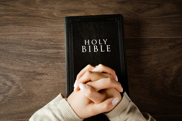 Woman praying on bible