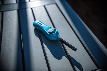 Blue barbeque lighter on a table. - obrazy, fototapety, plakaty