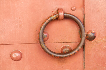 close-up doorknob of an old pink door