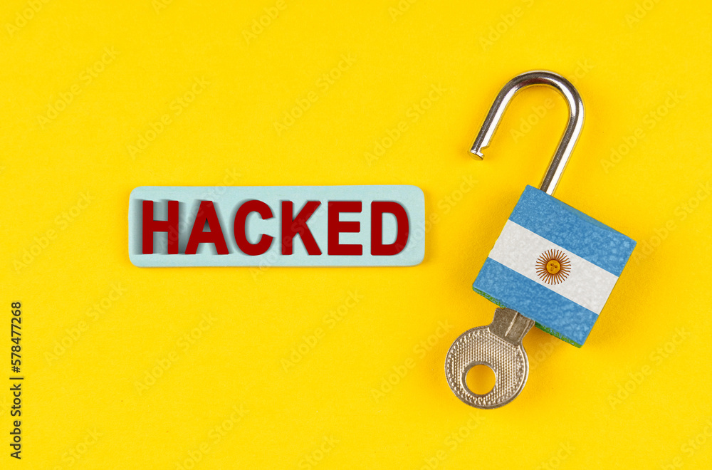 Poster on the yellow surface is an open lock with a key and a sticker with the inscription - hacked