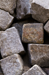 A pile of old large gray stone blocks.