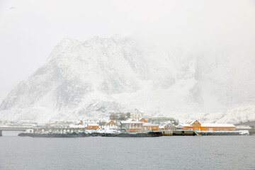 Reine fishing village on Lofoten islands with red rorbu houses in winter with snow. Lofoten islands, Norway, Europe