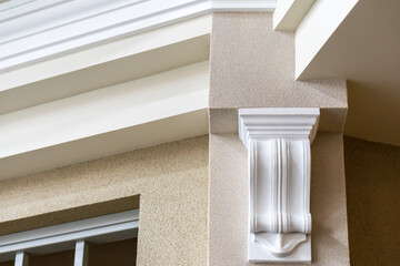 Ceiling moldings with an intricate crown in the inner corner. Home renovation, home decoration, real estate concept. White moldings on ceiling details. Interior design and architectural abstraction