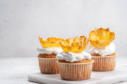 Delicious cupcakes topped with dried pineapple flowers