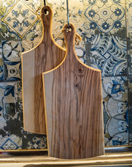 Wooden cutting boards  hanging  in the kitchen to dry 