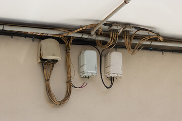 Close-up of some fiber optic internet and telephony cabling boxes visible on the street