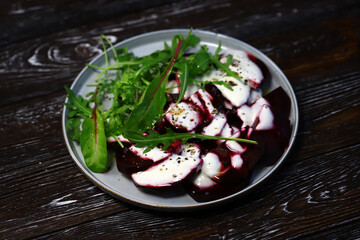 Healthy salad with beets and arugula with yogurt dressing. Vegan style food.