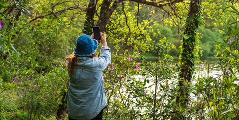 Woman lost in the forest, looking for cell phone coverage to find her way back
