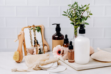 Fototapeta na wymiar Bottles shampoo or shower gel Lotion, essential oil, cream, massage brushes, Body and face care beauty bath set 