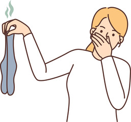 Woman disgusted with smelly dirty socks