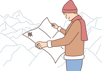 Male traveler with map in mountains