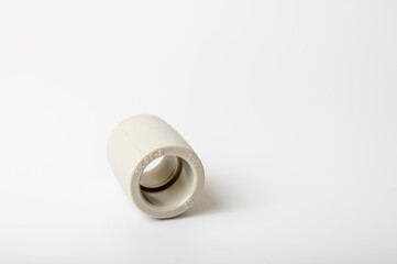 close-up, light PVC pipe tee, adapter connection for water isolated on light background