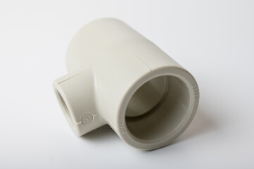 light PVC pipe tee connection for water isolated on light background close-up, connection for plumbing