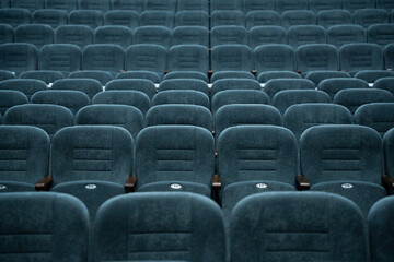 Empty rows of seats in the hall for a large number of people. Cinema and theatre hall for watching...