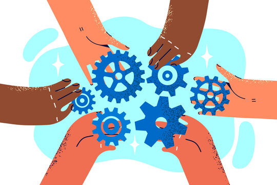 Close-up hands of company employees with variety of gears for concept of teamwork and collaboration