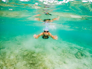 woman snorkeling in clear tropical sea