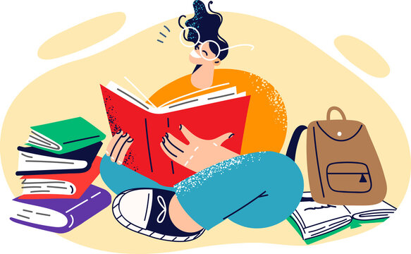 Young happy girl student sits on floor reading books and preparing for difficult exam