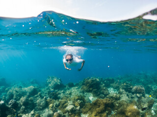 woman snorkeling in clear tropical sea