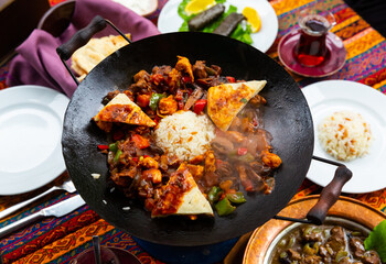 Traditional Turkish Choban Kavurma, hot stewed lamb meat with vegetables served with rice and bread