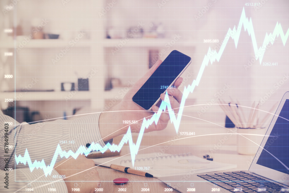 Poster double exposure of man's hands holding and using a digital device and forex graph drawing. financial