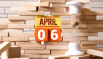 April 6th. Image of april 6 wooden color calendar on white background. Spring day, empty space for...