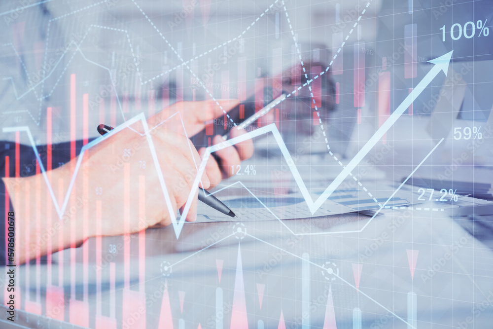 Poster double exposure of man's hands holding and using a phone and financial chart drawing. market analysi