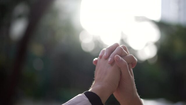 Closeup hands in union and support. People joining hand together outside in care and physical connection