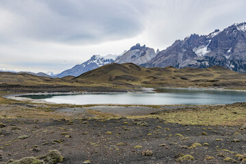 Impressive mountains and a lake with turquoise water at Torres del Paine National Park in Chile,...