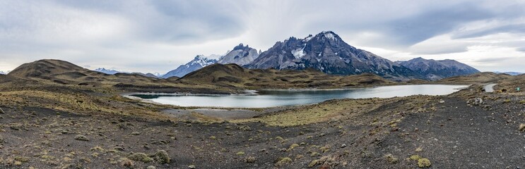 Impressive mountains and a lake with turquoise water at Torres del Paine National Park in Chile,...