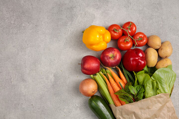 Healthy food in paper bag vegetables and on stone background. Food delivery, shopping food supermarket concept. Healthy food background. 