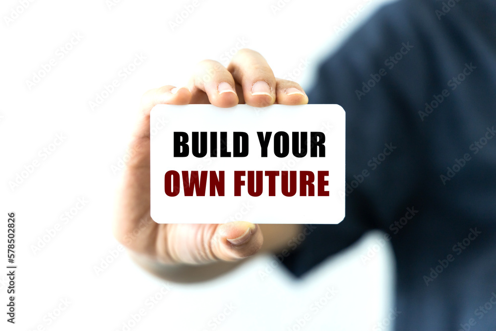 Poster build your own future text on blank business card being held by a woman's hand with blurred backgrou