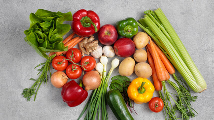 Naklejka na ściany i meble Flat lay of vegetables and fruits on grey background, top view. Healthy eating concept. 