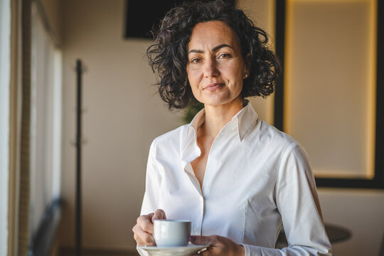 Mature Woman Having Cup Of Coffee At Home Or Office In Morning