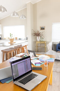 Close up of electronic devices and documents on table in living room