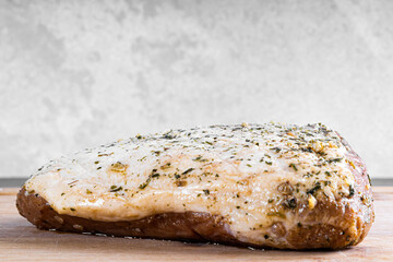 raw pork steak on wooden board