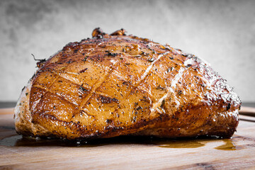 Roasted pork steak on a wooden board.