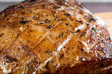 Roasted pork steak on a wooden board.