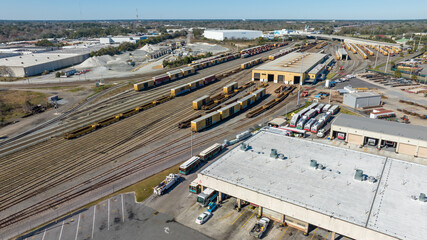 Aerial view of train tracks, trains, cargos.