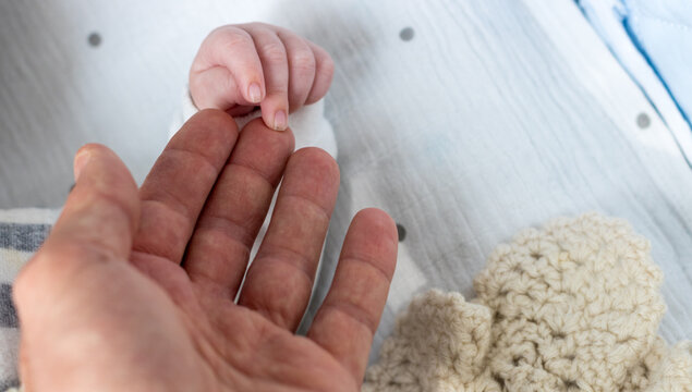 Cute newborn baby hand; childhood and happiness theme