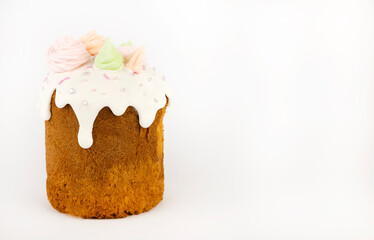 Traditional Ukrainian paska with sugar glaze and sugar sprinkles with colored meringue isolated on white background. Easter