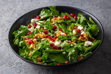 Arugula salad with cheese served with walnuts and pomegranate. Turkish name; Roka salatasi